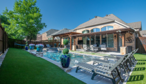 Backyard view of a residential property featuring a swimming pool, lounge chairs, and landscaping, illustrating outdoor living spaces relevant to property claims and maintenance.